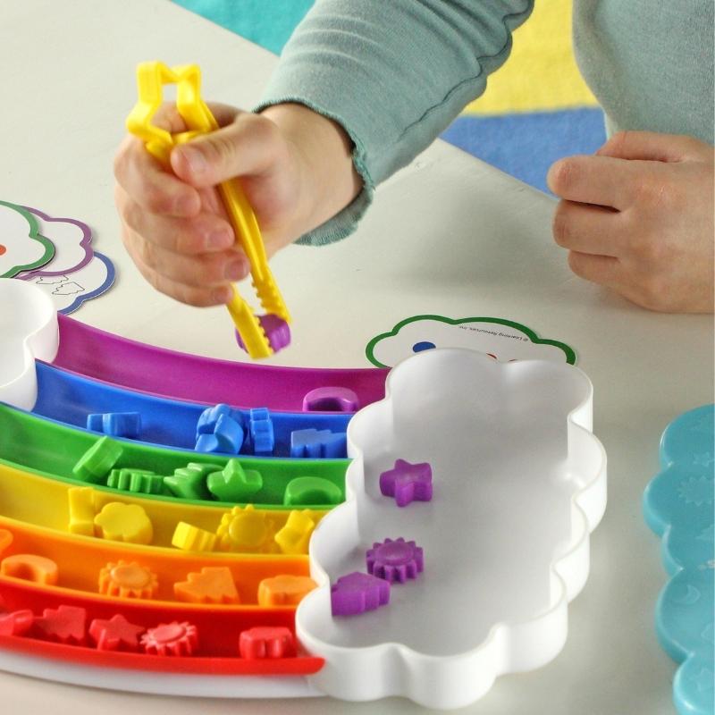 Kind sorteert alle paarse figuren in de regenboog